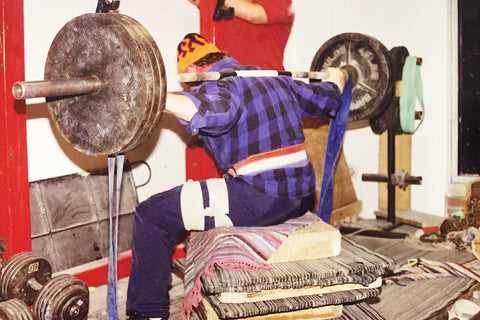 Chuck Vogelpohl box squatting using resistance bands with Louie Simmons Westside Barbell garage gym