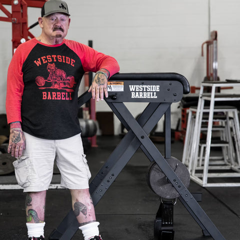 Louie Simmons standing by the scout reverse hyper at westside barbell gym